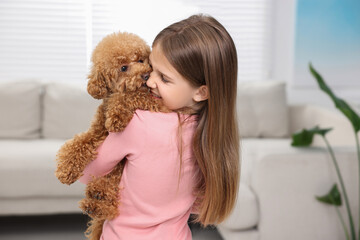 Little child with cute puppy at home. Lovely pet