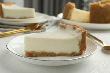 Piece of tasty vegan tofu cheesecake on white table, closeup