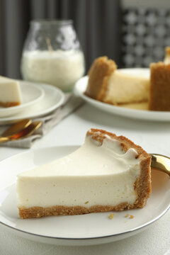 Piece of tasty vegan tofu cheesecake on white table, closeup. Space for text