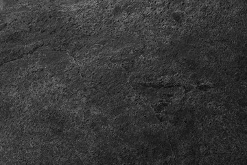 Texture of dark grey stone surface as background, closeup