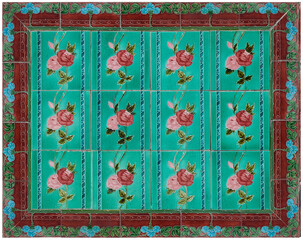 Rows of antique Nyonya Tiles with red and pink roses with green background. Vintage wall tile in Penang. Selective focus.