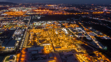 Aerial view oil terminal is industrial facility for storage of Oil and gas industry - refinery factory - petrochemical plant at night.
