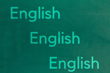 Fototapeta premium Background of old green wall. English letters on a green background