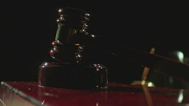 Closeup footage of wooden judge gavel on a desk with blur background. Justice concept