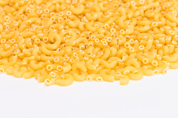 A Heap of Uncooked Chifferi Rigati Pasta on White Background. Fat and Unhealthy Food. Classic Dry Macaroni Texture. Italian Culture and Cuisine. Raw Pasta