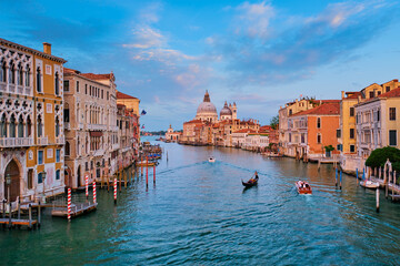 Panorama of Venice Grand Canal with boats and Santa Maria della Salute church on sunset from Ponte...