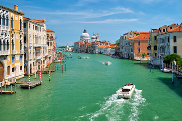 View of Venice Grand Canal with boats and Santa Maria della Salute church in the day from Ponte...