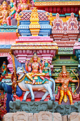 Shiva and Parvati on bull image. Sculptures on Hindu temple gopura (tower). Menakshi Temple, Madurai, Tamil Nadu, India