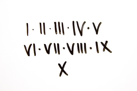 Roman numerals inscription with marker on a white board. Roman numerals from 1 to 10, I to X, learning, knowledge.