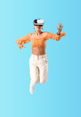 Jumping young woman with VR glasses on blue background