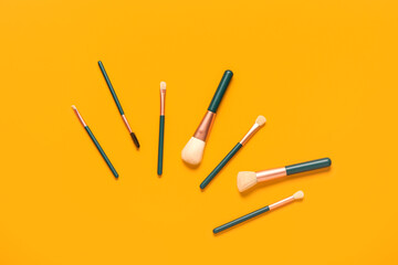 Makeup brushes on orange background