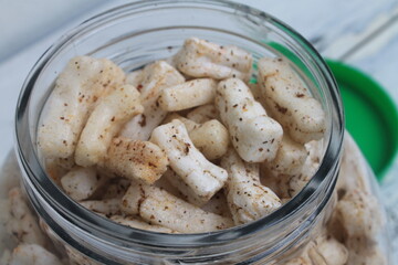 Indonesian snack spicy green chili crackers in a jar on the table 