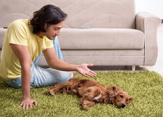 Young man with cocker spaniel dog