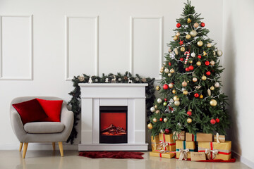 Interior of living room with fireplace, armchair and Christmas tree