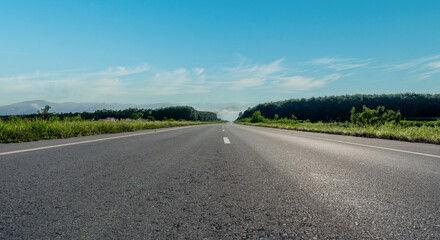 Empty asphalt road and mountain with blue sky scenery background.