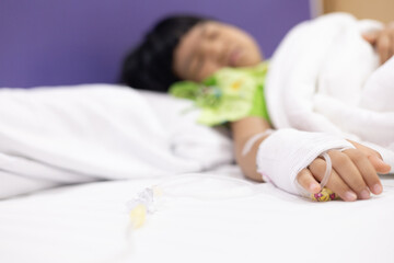 Child's hand fever patients have IV tube in hospital. Toddler girl wearing IV tube sleep in icu...