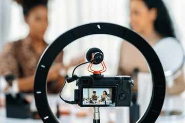 Woman influencer shoot live streaming vlog video review makeup crucial social media or blog. Happy young girl with cosmetics studio lighting for marketing recording session broadcasting online. - obrazy, fototapety, plakaty
