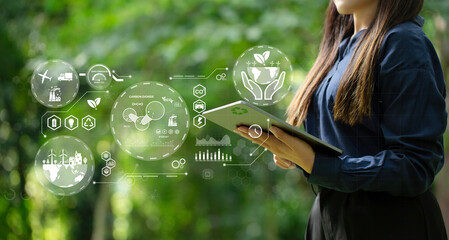 A woman holding a laptop with energy icons. green business. Ecosystem and Organization Development...