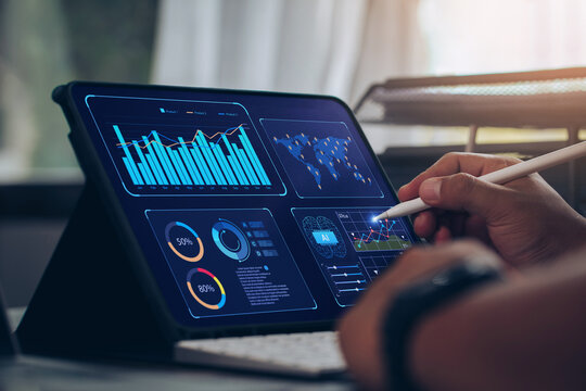 Businessman using tablet Analytics Data KPI Dashboard Tech with charts, metrics, and KPI to analyze performance and create insight reports for operations management.Data mining.Data analysis.Ai - Powered by Adobe