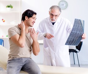 Young man visiting old male doctor radiologist