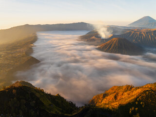 Aerial view Beautiful landscape scenery of Mount Bromo National Park from the top of the king kong hill,Amazing view landscape in indonesia,Beautiful sunrise and fog colorful sky background
