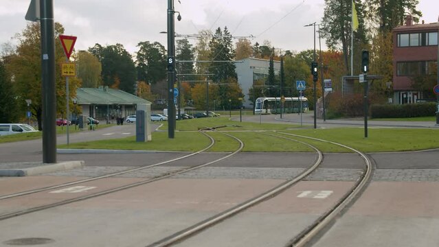 Electric commuter train on tracks in suburban Helsinki green space