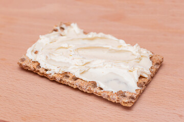Whole Grain Crispbread with Cream Cheese on Wooden Cutting Board. Quick and Healthy Sandwiches....