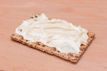Whole Grain Crispbread with Cream Cheese on Wooden Cutting Board. Quick and Healthy Sandwiches. Healthy Dietary Snack