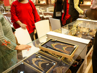 Bangalore, India 4th November 2023: Indian customer in a jewellery exhibition buying gold on the...