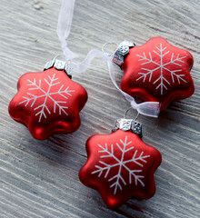 Christmas tree decoration in the form of red snowflakes made of metal