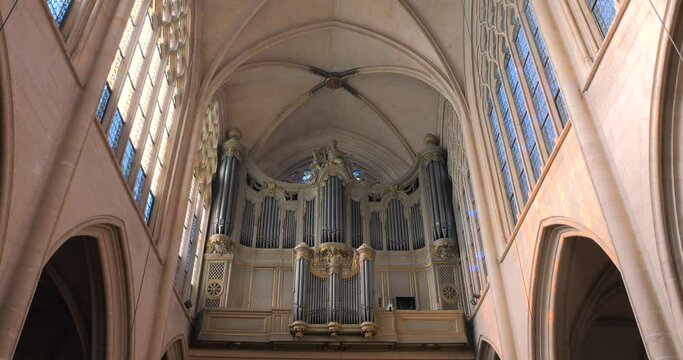 Low angle shot of pipe organ in the interior of a roman catholic church of Saint-Germain-l'Auxerrois in Paris, France at daytime.