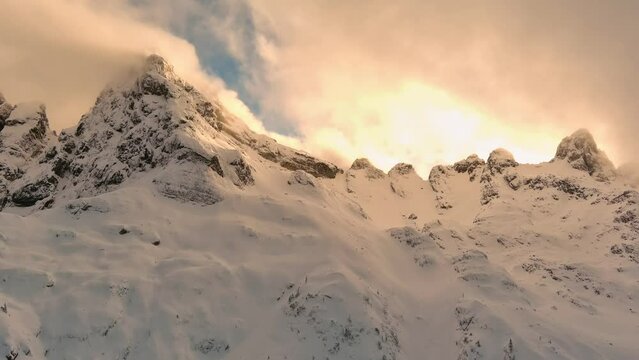 Mountain Peaks Covered in Fresh Snow. Canadian Landscape. Cloudy, Wintertime. Dramatic Sunset. High quality 4k footage