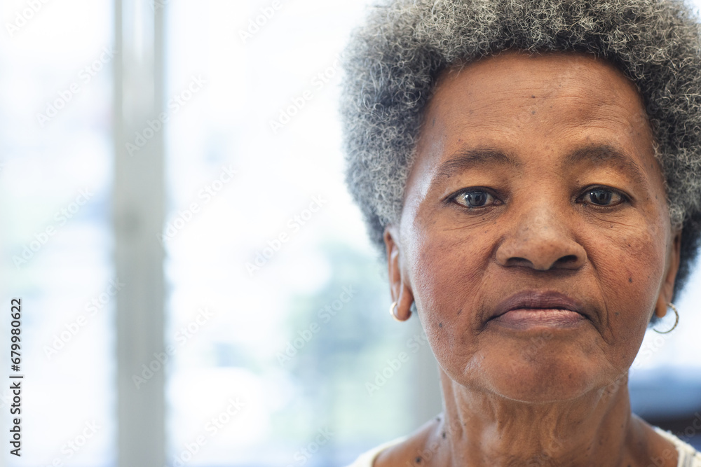 Wall mural Portrait of african american woman in hospital waiting room with copy space