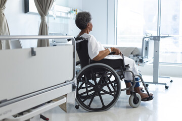 African american senior female patient in wheelchair in sunny hospital room