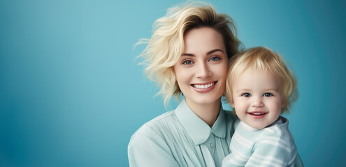 Fashion smiling mother holding her kid on solid color background, love concept