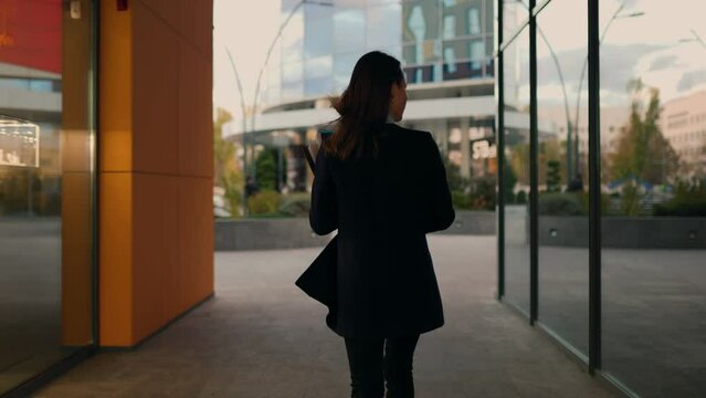 City Stride Triumph A concise portrayal of a white-collar worker in a back view tracking shot, navigating the urban environment with confidence, professionalism, and style. rear view