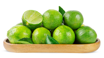 Green lime fruits with leaves in a wooden plate isolated on a white background