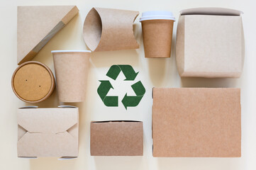 Green recycling sign and a set of eco-friendly disposable tableware. Zero waste concept for...