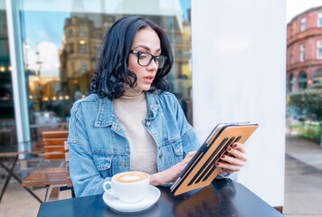 happy woman student e learning distance training course study working in cafe, drinking coffee, watching online education, webinar using laptop