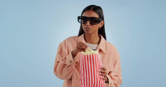 Funny, 3d glasses and woman with popcorn, movie and entertainment on a blue studio background. Person, girl and model with cinema snack, eyewear and streaming a film with humor, comedy and laughing