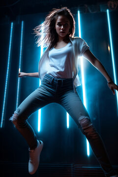 A beautiful young girl dances dynamically and passionately, illuminated by colorful neon lights. Let's go to a party!