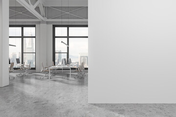 White industrial open space office with blank wall