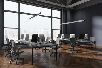 Grey coworking interior with table and pc monitors in row, panoramic window