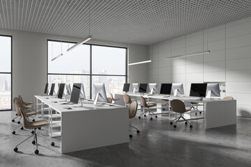 Modern business interior with chairs and pc monitors, desk in row near window