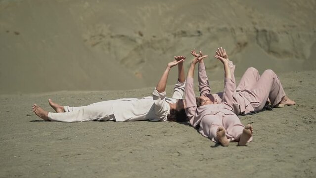 many women's hands. female hands. woman and sand. three women lie on the sand. Full HD video recording