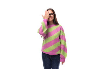 pretty beautiful young european brunette woman with vision glasses dressed in casual striped pink green pullover