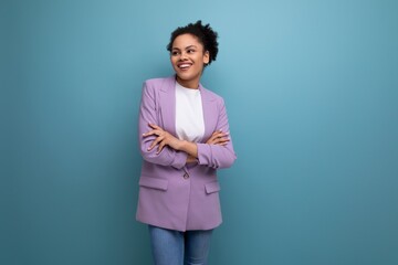young successful latin business woman dressed in lilac jacket isolated studio background with copy...