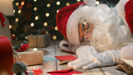 Santa Claus falling asleep at his desk