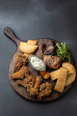 Ribs, chicken nuggets on a board