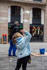 Winter Magic in the Gothic Quarter: Child's Play with Giant Soap Bubbles in Barcelona's Historic Streets